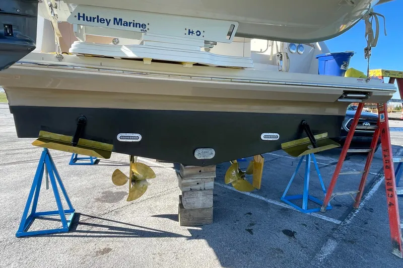 Slide: The Image of 2013 Carver C34 boat on stands, showing propellers and hull details. - 47