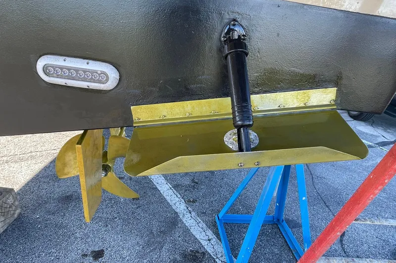 Slide: The Image of 2013 Carver C34 boat propeller and trim tab on a stand. - 48