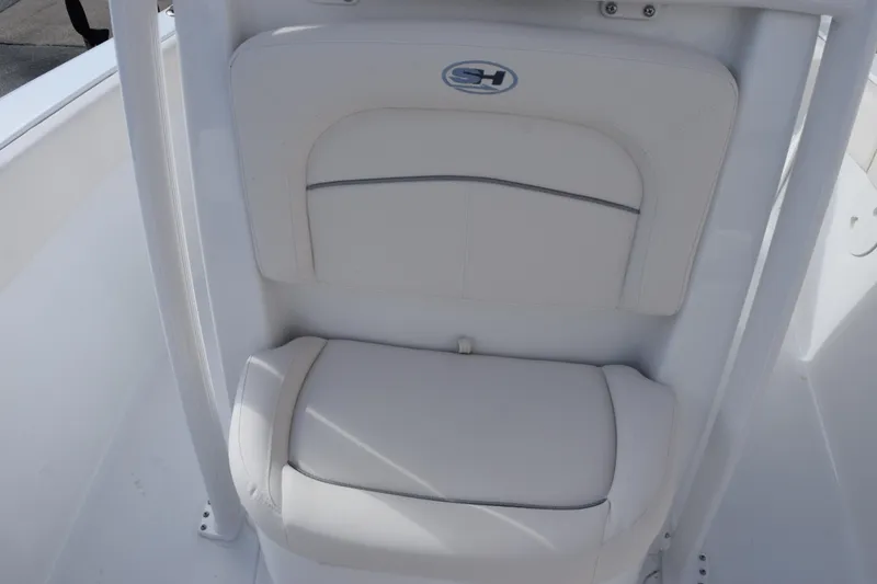 Slide: The Image of 2026 Sea Hunt Ultra 219 boat seat with white cushioned design. - 10