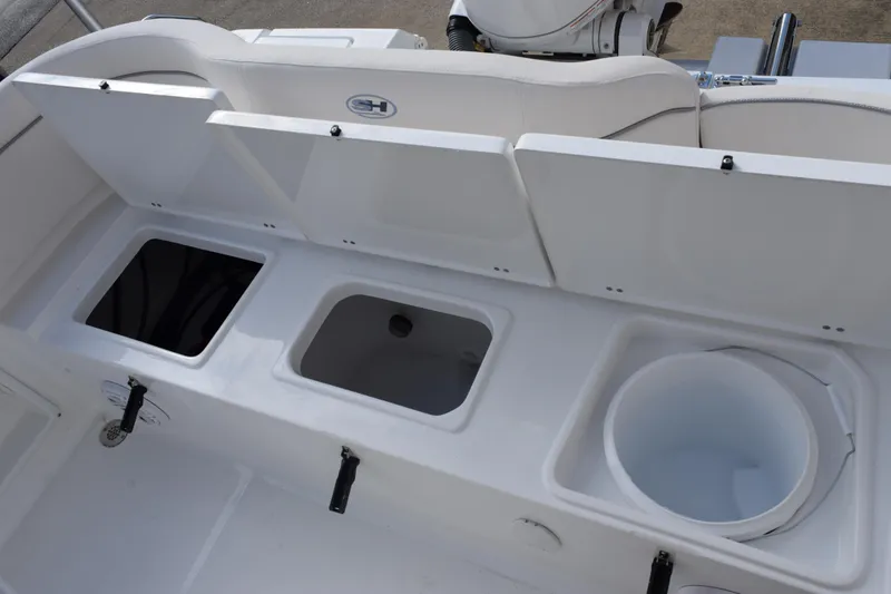 Slide: The Image of 2026 Sea Hunt Ultra 219 boat storage compartments and seating area. - 15