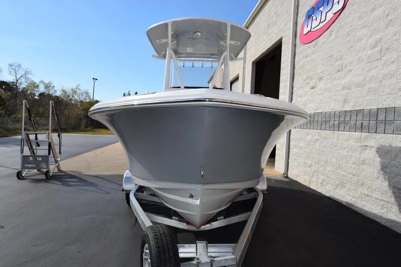 Slide: The Image of 2026 Sea Hunt Ultra 219 boat on trailer outside a building. - 3