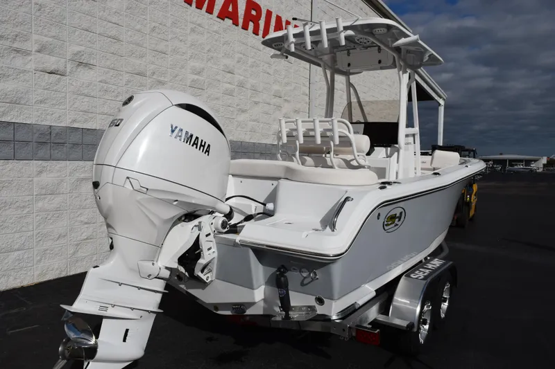 Slide: The Image of 2026 Sea Hunt Ultra 219 boat with Yamaha engine, parked outside a marine store. - 4