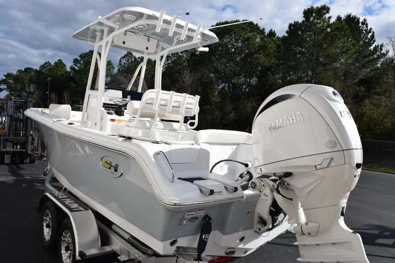 Slide: The Image of 2026 Sea Hunt Ultra 219 boat with Yamaha engine on trailer, parked outdoors. - 5