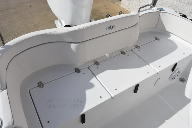 Slide: The Image of 2026 Sea Hunt Ultra 219 boat interior with white seating and storage compartments. - 6