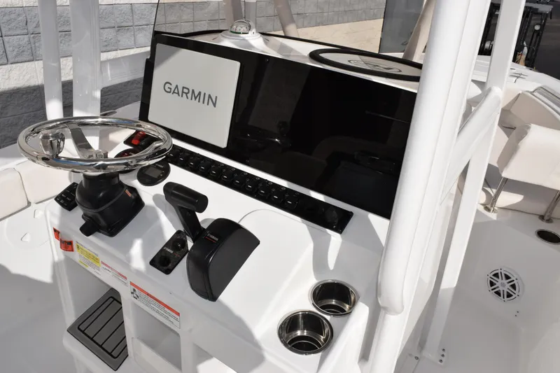 Slide: The Image of 2026 Sea Hunt Ultra 219 boat console with Garmin navigation system and steering wheel. - 7