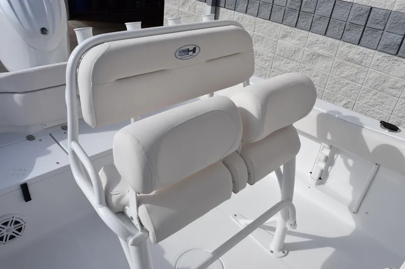 Slide: The Image of 2026 Sea Hunt Ultra 219 boat seating with white cushioned backrest and armrests. - 8