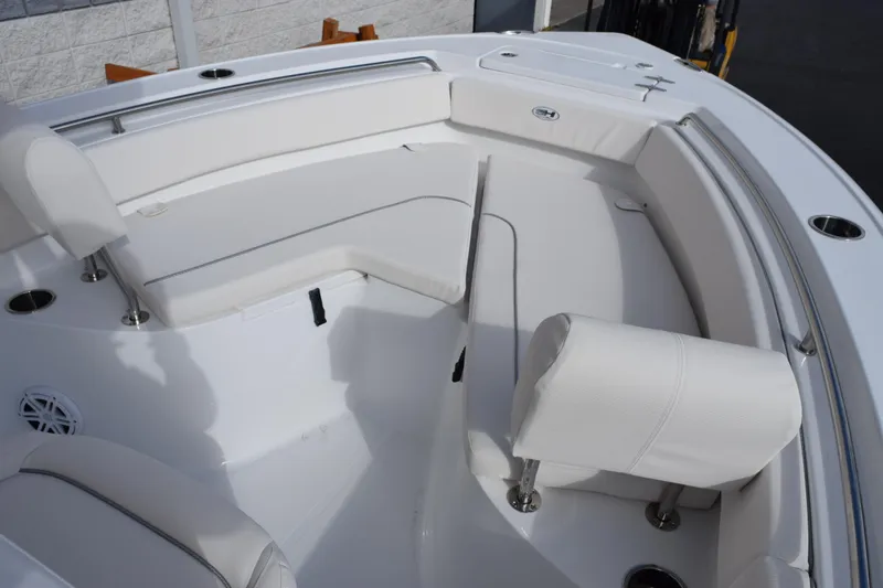 Slide: The Image of 2026 Sea Hunt Ultra 219 boat interior with white cushioned seating. - 9