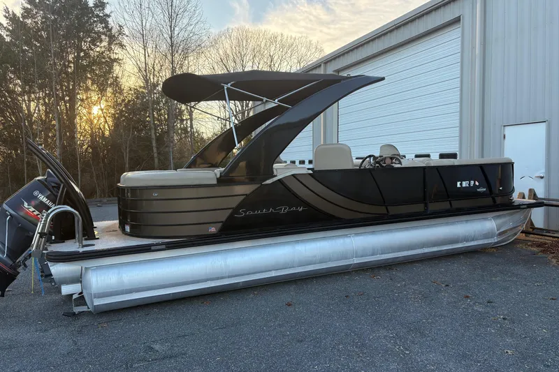 Slide: The Image of 2019 South Bay 525 RS 3.0 Arch pontoon boat with Yamaha engine, parked outdoors. - 2