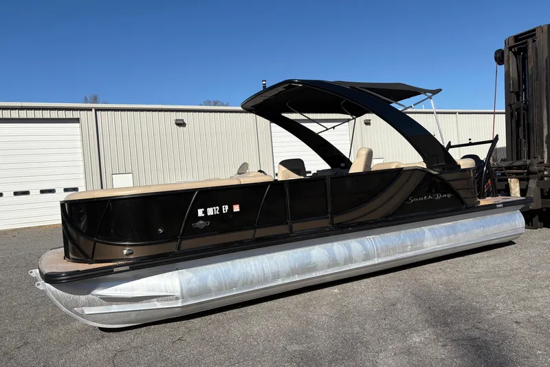 Slide: The Image of 2019 South Bay 525 RS 3.0 Arch pontoon boat parked outdoors. - 3