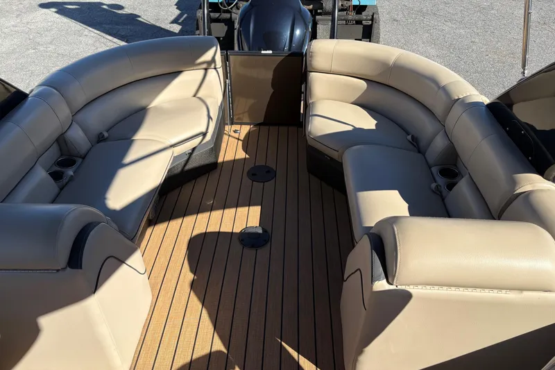 Slide: The Image of 2019 South Bay 525 RS 3.0 Arch boat interior with beige seating and wooden deck. - 9