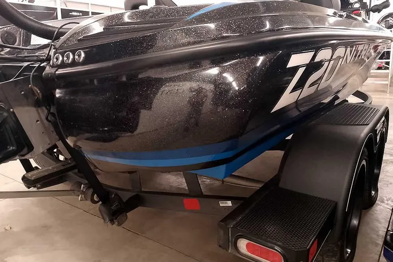 Slide: The Image of 2022 Nitro Z20 boat on trailer, black with blue accents, in showroom. - 13