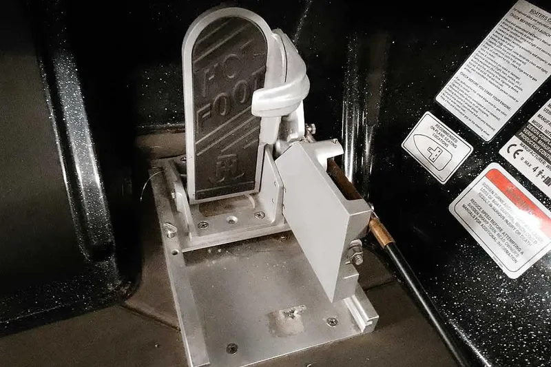 Slide: The Image of Foot pedal mechanism in a 2022 Nitro Z20 boat, featuring safety labels and controls. - 29