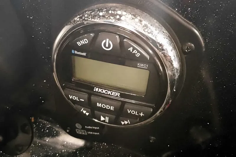 Slide: The Image of Kicker audio system in 2022 Nitro Z20 boat, featuring Bluetooth and volume controls. - 31