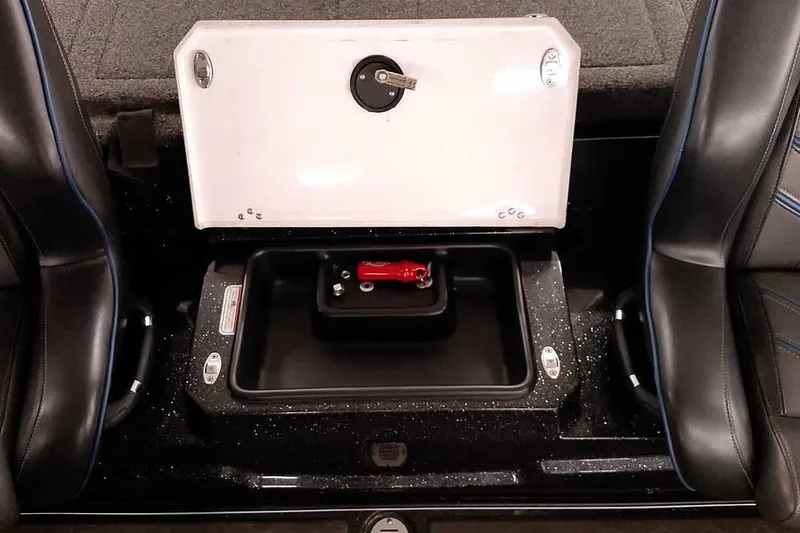 Slide: The Image of 2022 Nitro Z20 boat storage compartment with open lid and red safety key. - 34