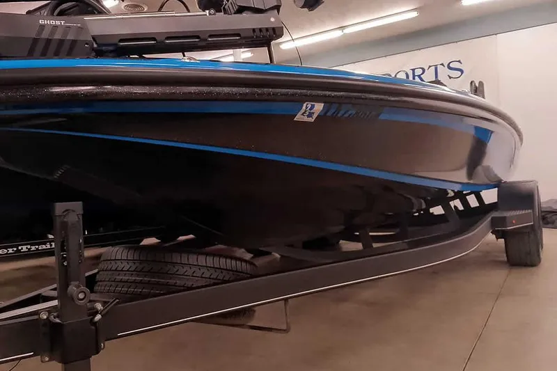 Slide: The Image of 2022 Nitro Z20 boat on trailer, black and blue design, indoor showroom. - 5