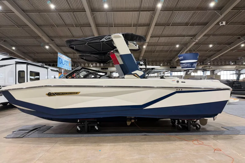 The Image of 2026 Nautique Super Air Nautique G25 boat displayed indoors at a boat show. - 0
