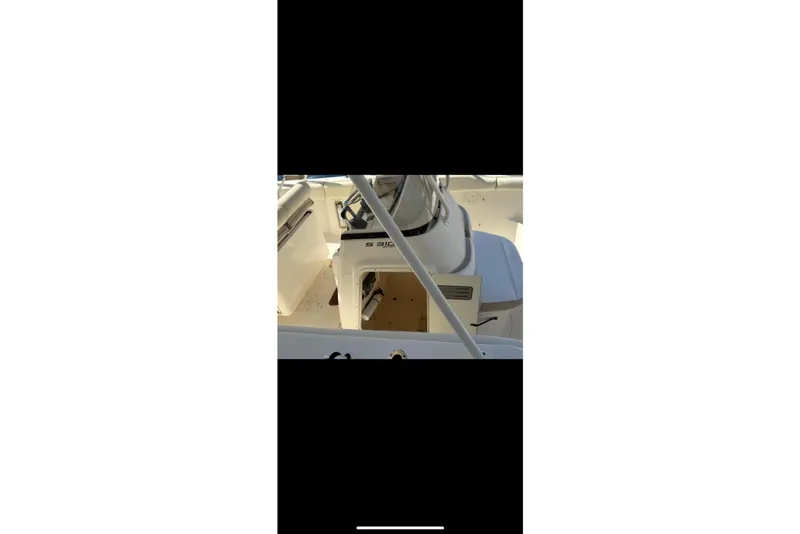 Slide: The Image of 2009 Pursuit S 310 Sport boat interior with seating and control panel. - 13