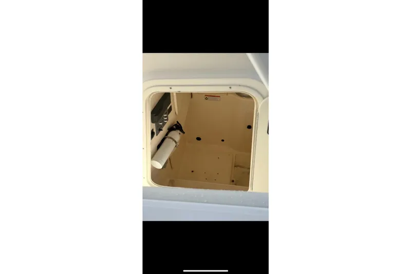 Slide: The Image of 2009 Pursuit S 310 Sport boat cockpit with steering wheel and control panel. - 14