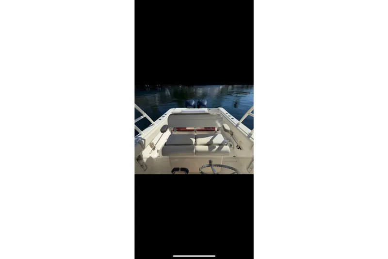 Slide: The Image of 2009 Pursuit S 310 Sport boat dashboard with steering wheel and navigation controls. - 15