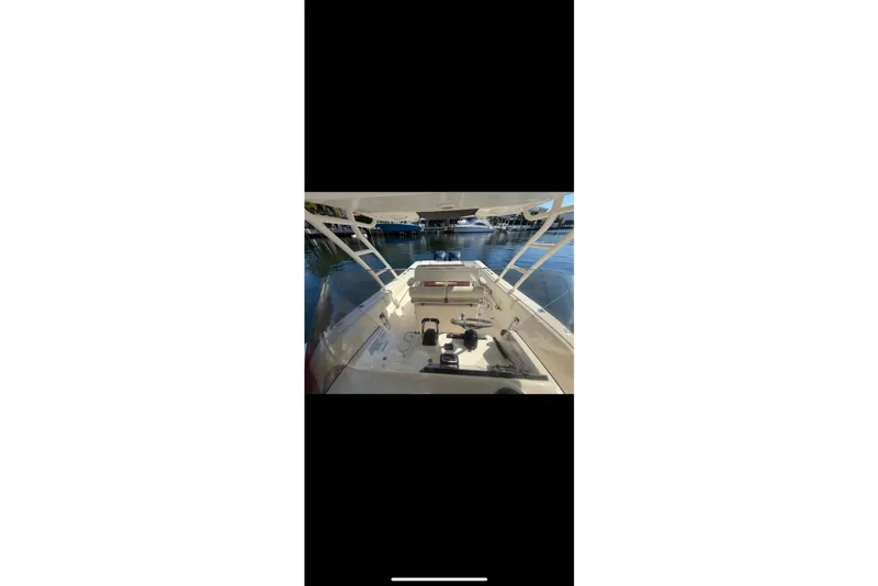 Slide: The Image of 2009 Pursuit S 310 Sport boat interior with open cabin door and seating. - 16