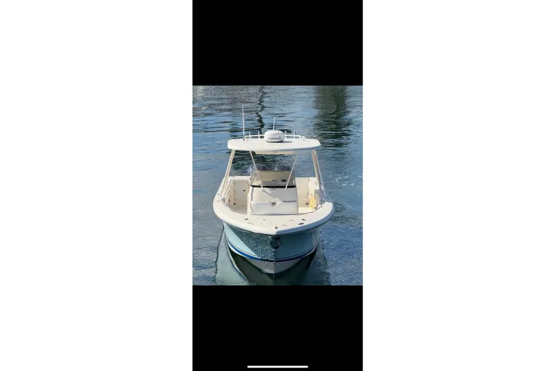 Slide: The Image of 2009 Pursuit S 310 Sport boat on calm water, front view. - 5