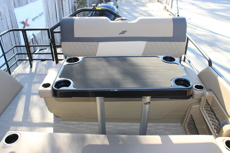 Slide: The Image of 2026 Starcraft EXS 3 DL boat interior with table and cup holders. - 11