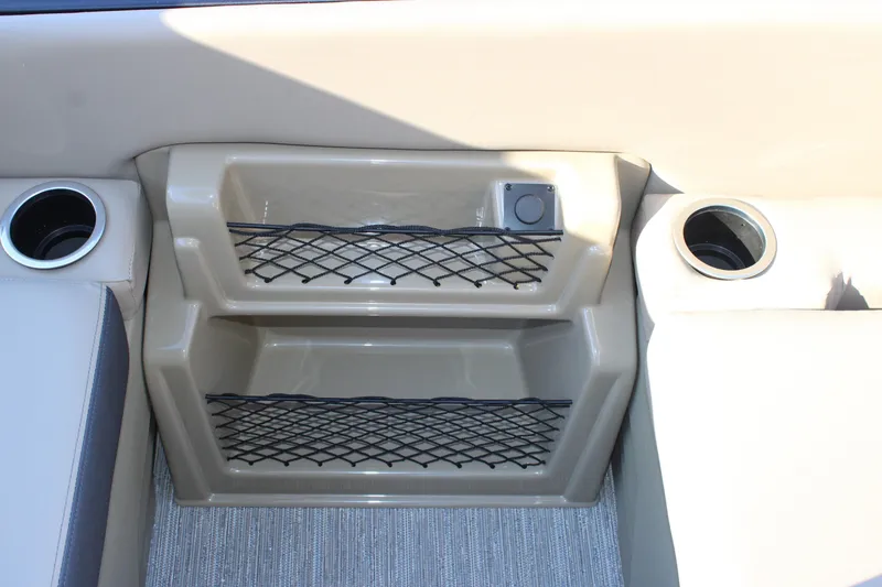 Slide: The Image of 2026 Starcraft EXS 3 DL boat interior with cup holders and storage compartments. - 12