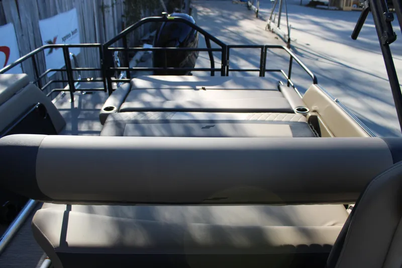 Slide: The Image of 2026 Starcraft EXS 3 DL boat interior with cushioned seating and railing. - 16