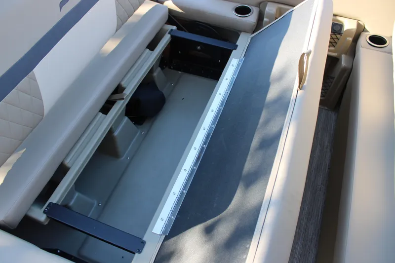 Slide: The Image of 2026 Starcraft EXS 3 DL boat interior storage compartment with beige seating. - 20