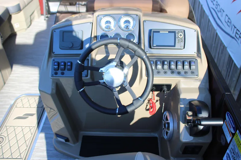 Slide: The Image of 2026 Starcraft EXS 3 DL boat dashboard with steering wheel and control panel. - 22