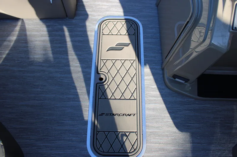 Slide: The Image of Floor panel of 2026 Starcraft EXS 3 DL boat with logo and textured design. - 26