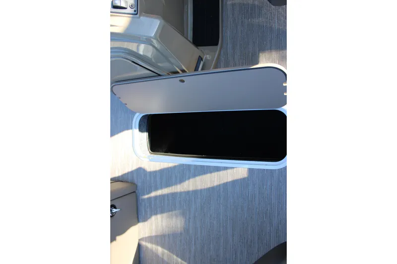 Slide: The Image of Open storage compartment on 2026 Starcraft EXS 3 DL boat interior. - 27