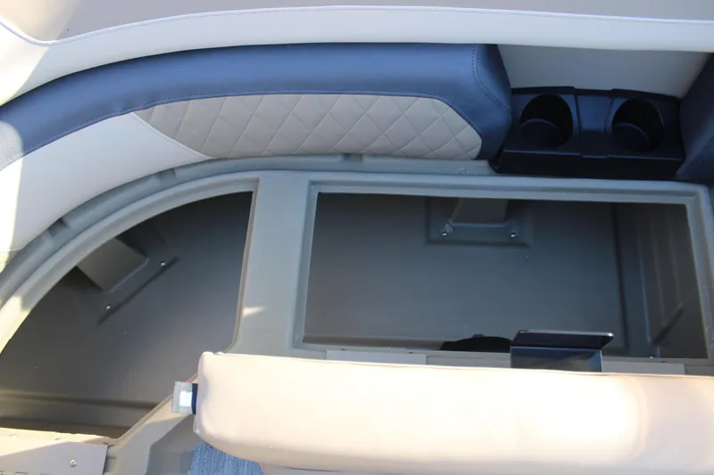 Slide: The Image of 2026 Starcraft EXS 3 DL boat interior storage compartment with cup holders. - 33