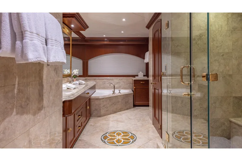 Slide: The Image of Luxurious yacht bathroom with marble decor, glass shower, and elegant wood cabinetry, 2001 TRINITY Tri-Deck MY. - 10