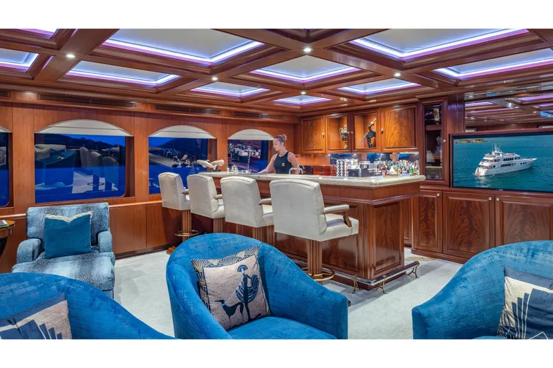 Slide: The Image of Luxurious interior of 2001 TRINITY Tri-Deck MY yacht with elegant bar and seating area. - 25
