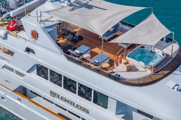 Slide: The Image of Luxurious 2001 TRINITY Tri-Deck MY yacht with sun deck, jacuzzi, and shaded lounge area. - 37