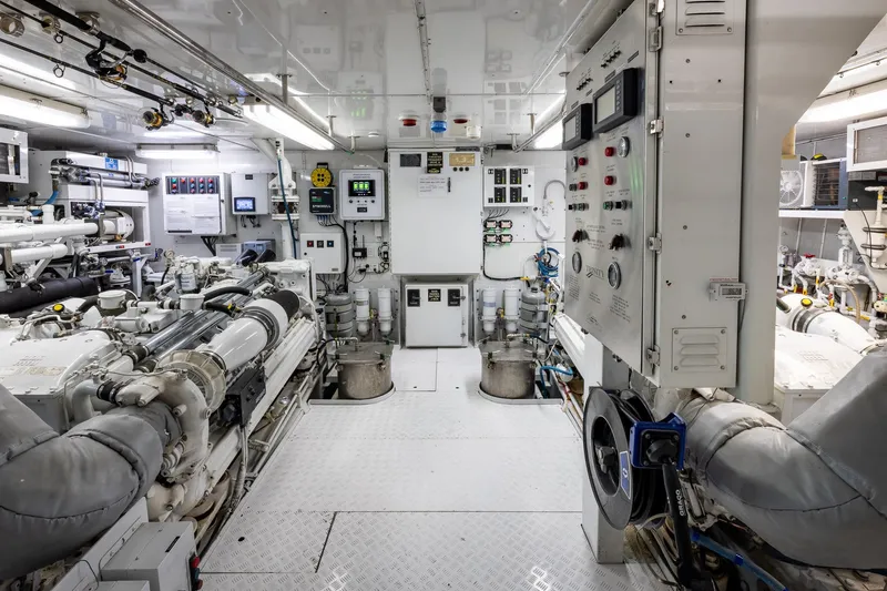 Slide: The Image of Engine room of 2001 TRINITY Tri-Deck MY yacht, featuring advanced machinery and control panels. - 42