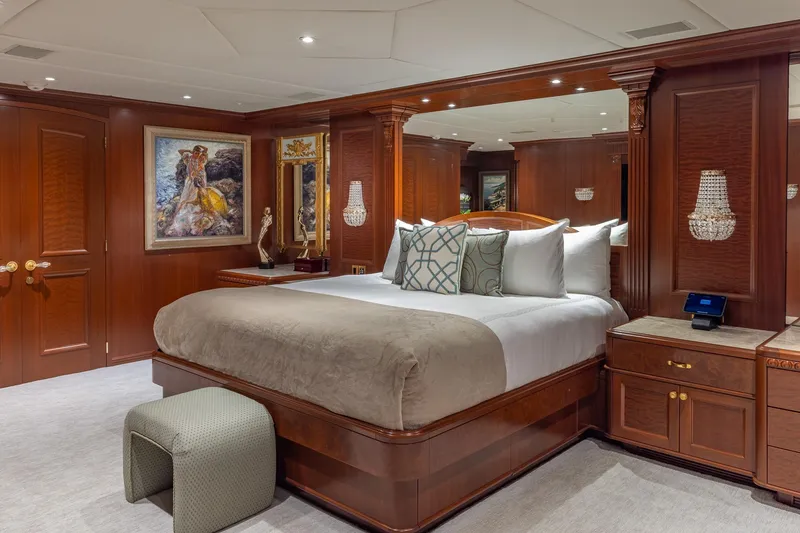 Slide: The Image of Luxurious bedroom on 2001 TRINITY Tri-Deck MY yacht with elegant wood paneling and plush bedding. - 7