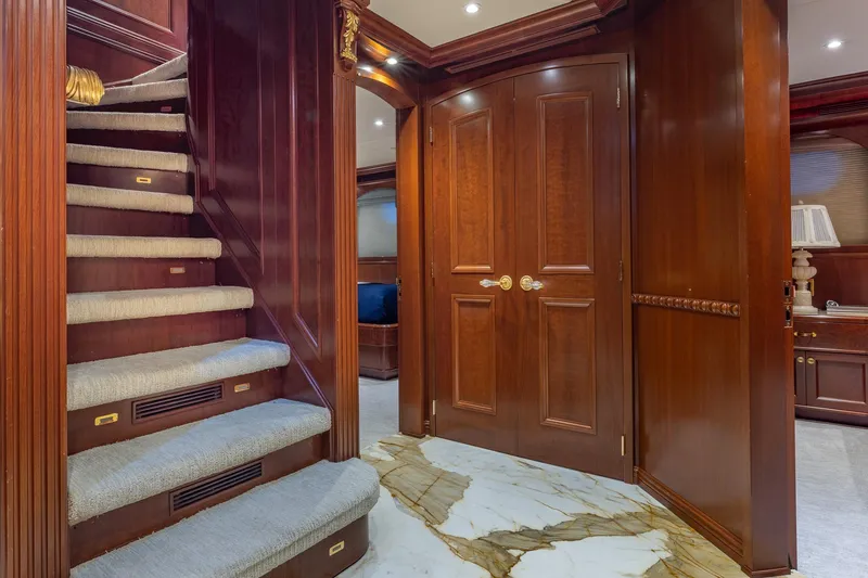 Slide: The Image of Luxurious wooden interior of 2001 TRINITY Tri-Deck MY yacht with elegant staircase and marble flooring. - 12