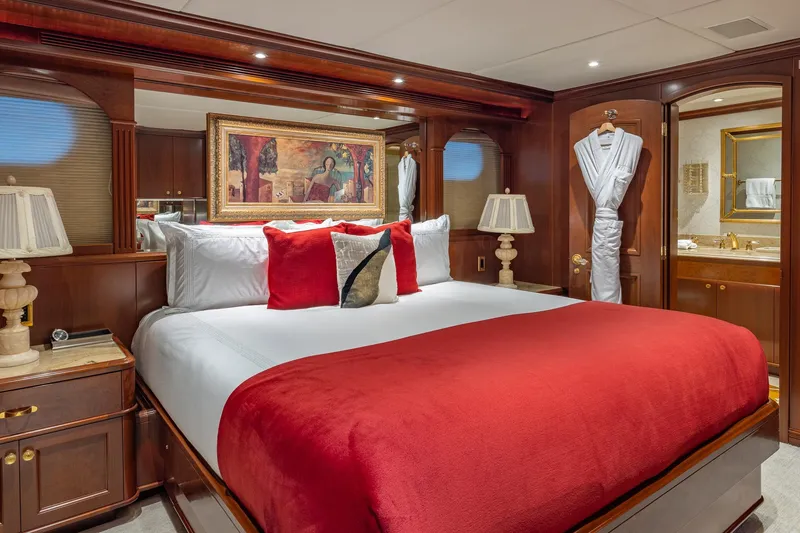 Slide: The Image of Luxurious bedroom on 2001 TRINITY Tri-Deck MY yacht with elegant decor and red accents. - 13