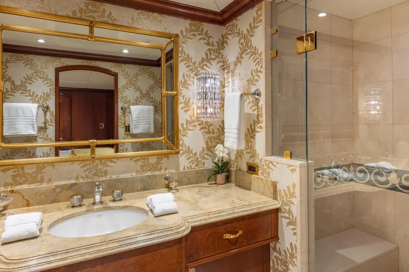 Slide: The Image of Luxurious bathroom on 2001 TRINITY Tri-Deck MY yacht with elegant gold accents and marble countertop. - 17
