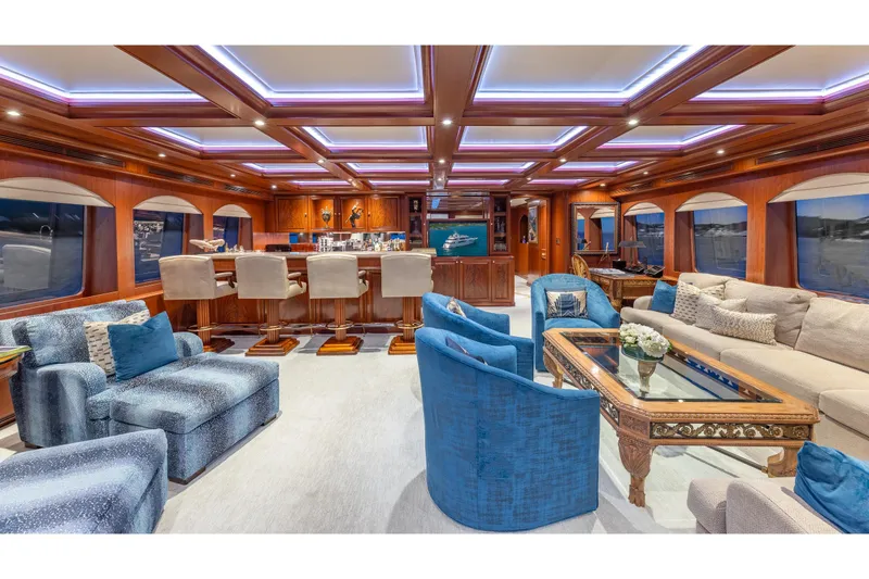 Slide: The Image of Luxurious interior of 2001 TRINITY Tri-Deck MY yacht with elegant seating and ambient lighting. - 23