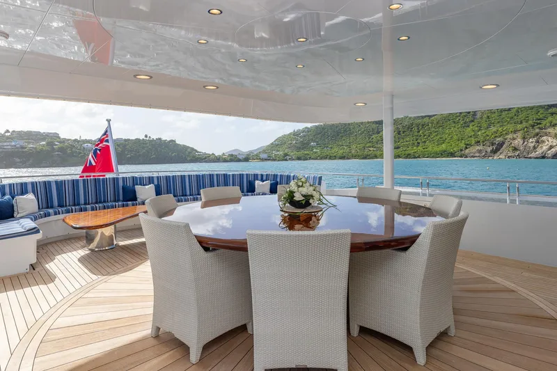 Slide: The Image of Luxurious 2001 TRINITY Tri-Deck MY yacht deck with elegant dining area and scenic ocean view. - 27