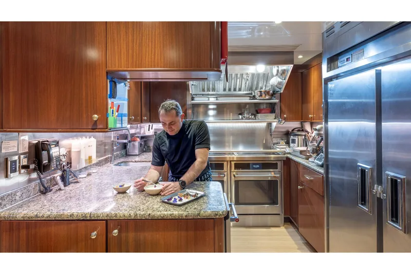 Slide: The Image of Chef preparing food in a luxurious yacht kitchen, TRINITY Tri-Deck MY 2001. - 29