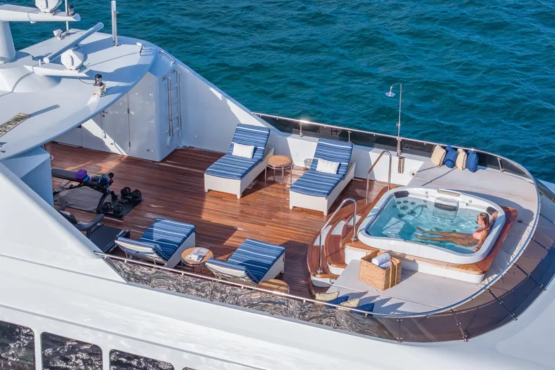 Slide: The Image of Luxurious 2001 TRINITY Tri-Deck MY yacht with sun deck, jacuzzi, and lounge chairs. - 35