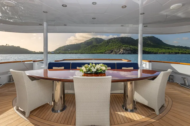 Slide: The Image of Luxurious yacht deck with elegant dining area, scenic ocean and island views. TRINITY Tri-Deck MY 2001. - 40
