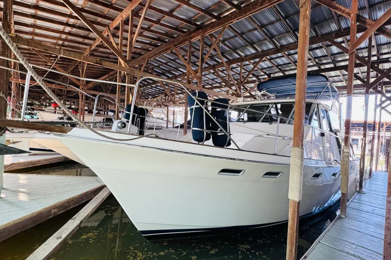 Slide: The Image of 1987 Bayliner 4550 Motoryacht docked in a covered marina. - 10