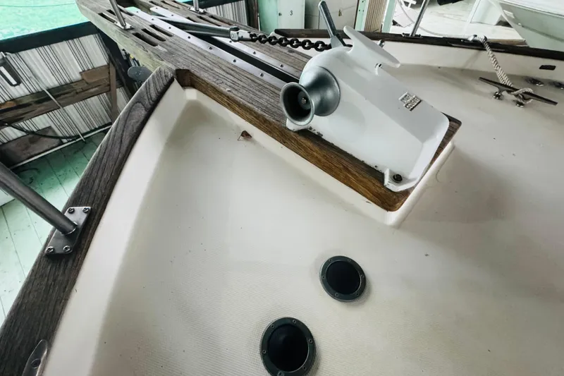 Slide: The Image of 1987 Bayliner 4550 Motoryacht deck with winch and wooden trim details. - 14