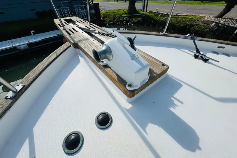 Slide: The Image of 1987 Bayliner 4550 Motoryacht deck with anchor winch and wooden details. - 19