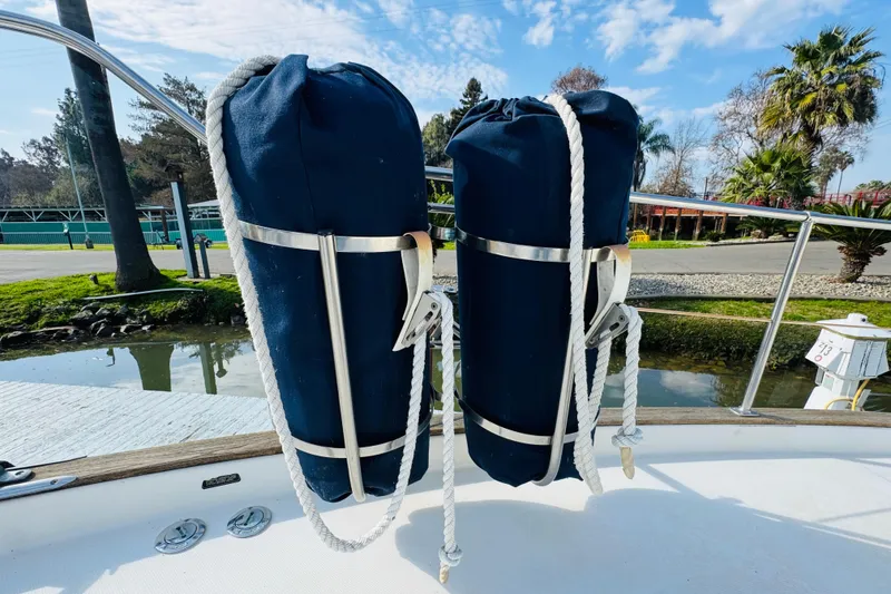 Slide: The Image of 1987 Bayliner 4550 Motoryacht deck with blue fenders and scenic marina view. - 20